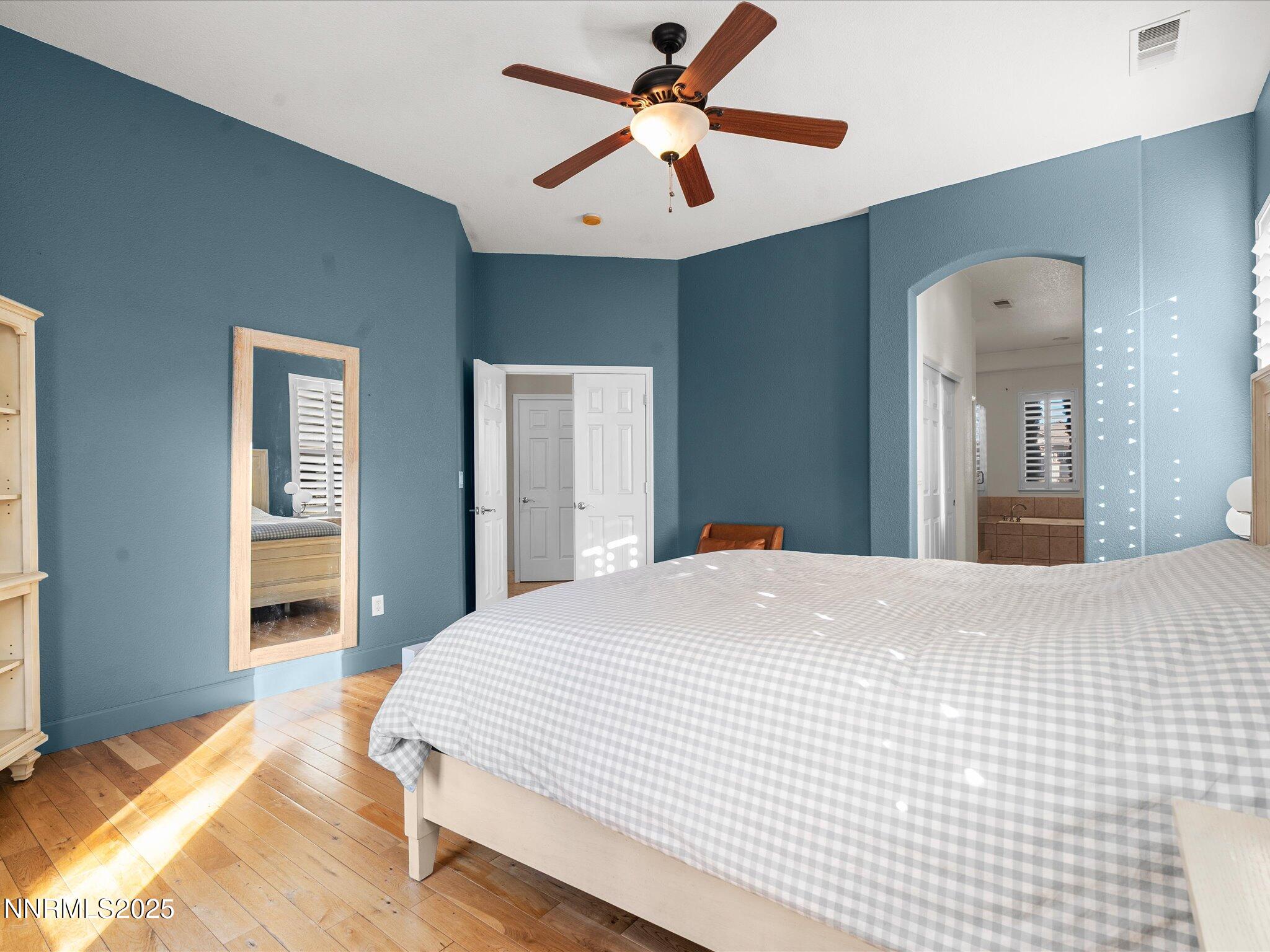 5519 New Mexico Court Reno, NV 89511 - Photo 26 of 60 a bedroom with a bed and a chandelier