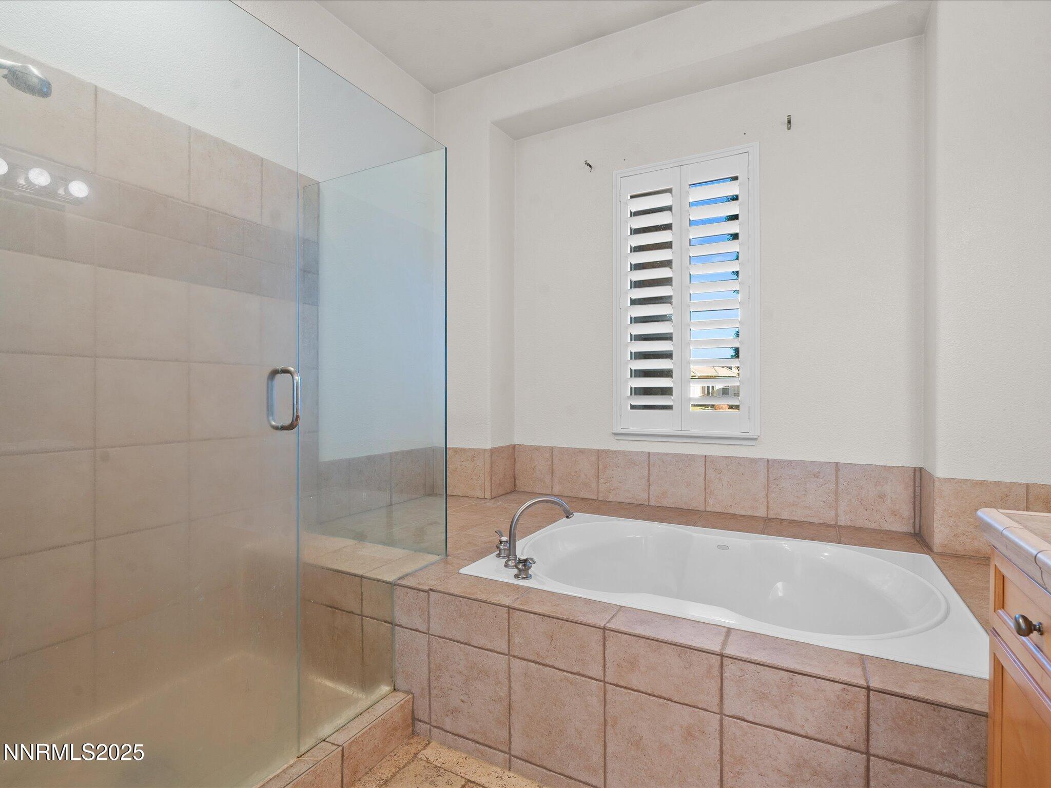 5519 New Mexico Court Reno, NV 89511 - Photo 29 of 60 a bathroom with a bathtub and a shower