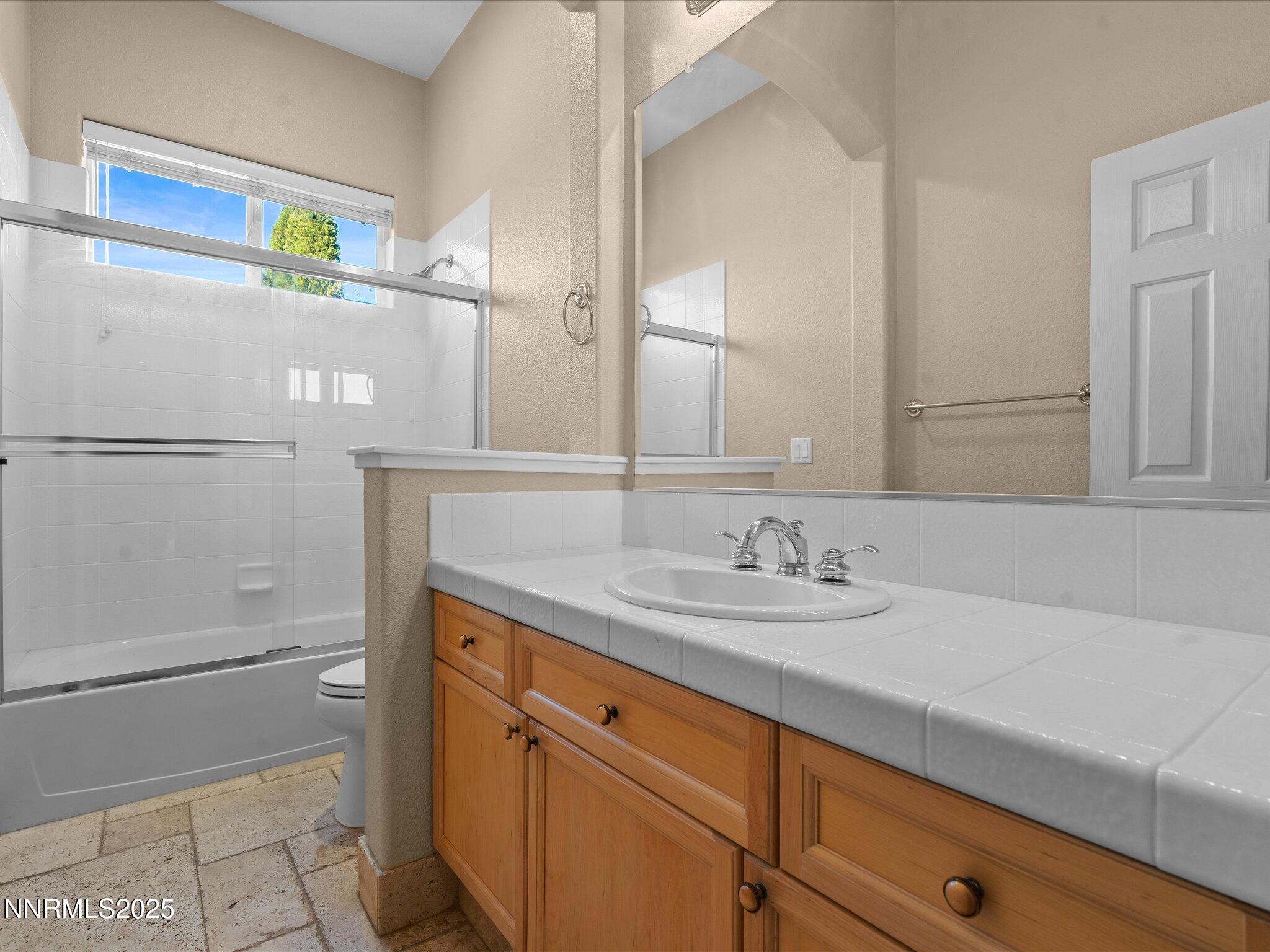 5519 New Mexico Court Reno, NV 89511 - Photo 35 of 60 a bathroom with a sink and a mirror