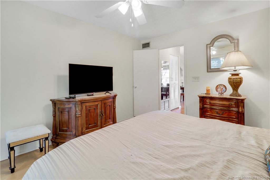 2929 Southeast Ocean Boulevard, Unit 1049 Stuart, FL 34996 - Photo 17 of 31 a bedroom with a bed and a flat screen tv