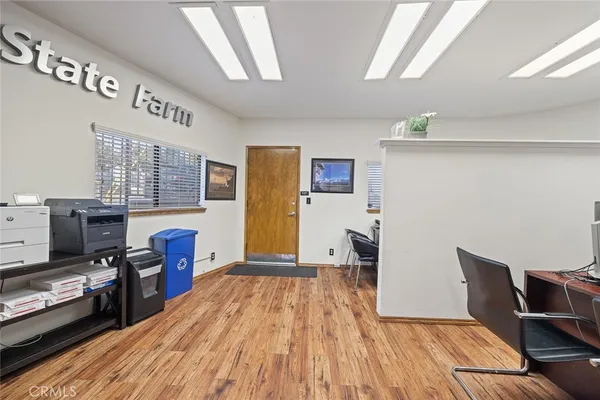 a workspace with furniture and wooden floor