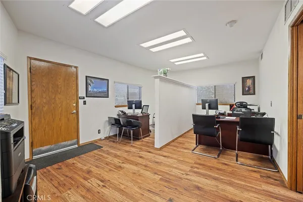 a view of a workspace with furniture and a window