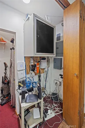 a view of a hallway with wooden floor and closet