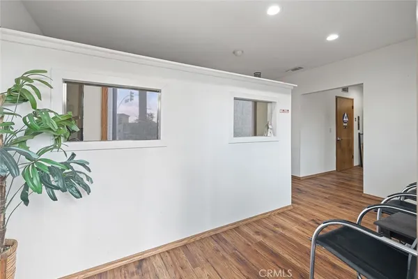 a work room with furniture and a potted plant