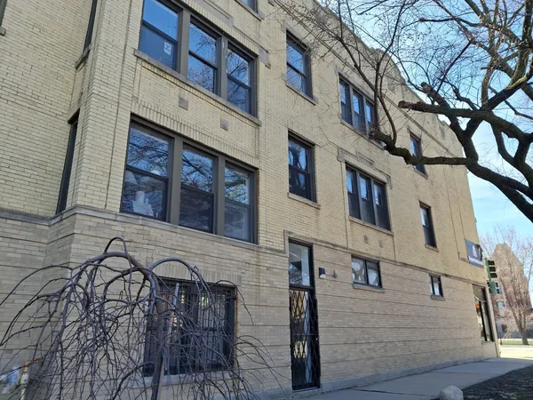 a view of a brick building with many windows
