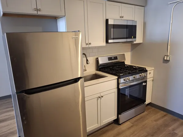 a kitchen with a refrigerator stove and microwave