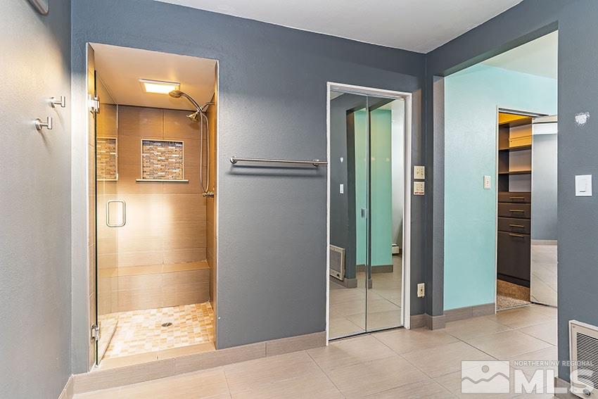 1380 Belford Road Reno, NV 89509 - Photo 12 of 22 a view of a bathroom with a glass door