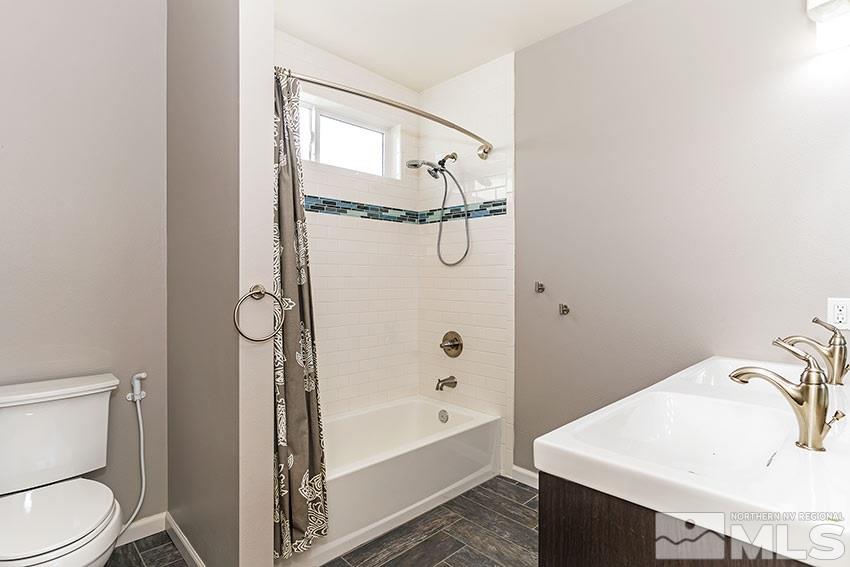 1380 Belford Road Reno, NV 89509 - Photo 15 of 22 a bathroom with a sink a toilet and shower