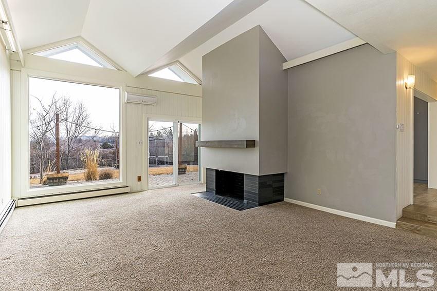 1380 Belford Road Reno, NV 89509 - Photo 2 of 22 a living room with a fireplace and large window