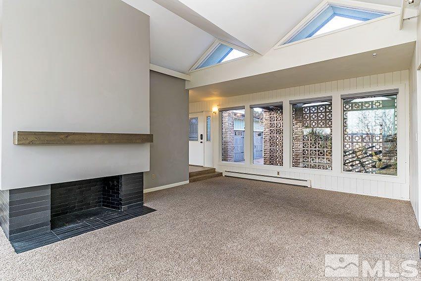 1380 Belford Road Reno, NV 89509 - Photo 4 of 22 a view of an empty room with a fireplace and a window