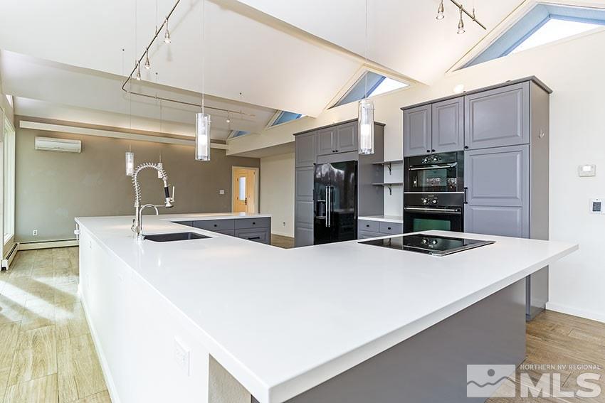 1380 Belford Road Reno, NV 89509 - Photo 6 of 22 a kitchen with stainless steel appliances a sink and a refrigerator