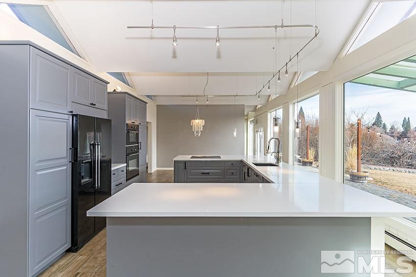 1380 Belford Road Reno, NV 89509 - Photo 7 of 22 a kitchen with kitchen island a counter top space a sink stainless steel appliances and cabinets