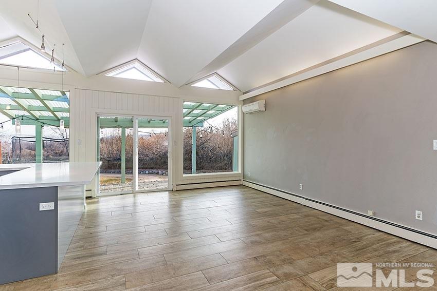1380 Belford Road Reno, NV 89509 - Photo 8 of 22 a view of an empty room with wooden floor and a window