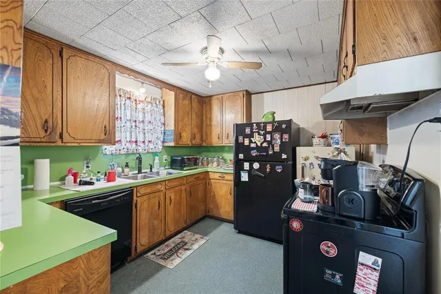 a kitchen with refrigerator and cabinets