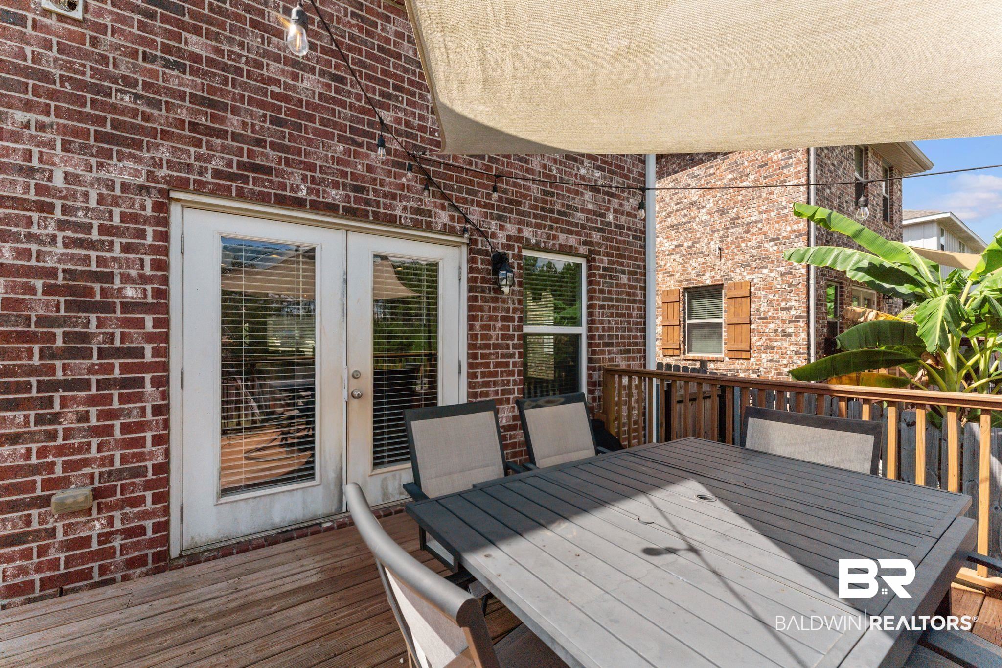 12711 Chickadee Lane Daphne, AL 36527 - Photo 29 of 39 Wooden deck featuring outdoor dining space and french doors