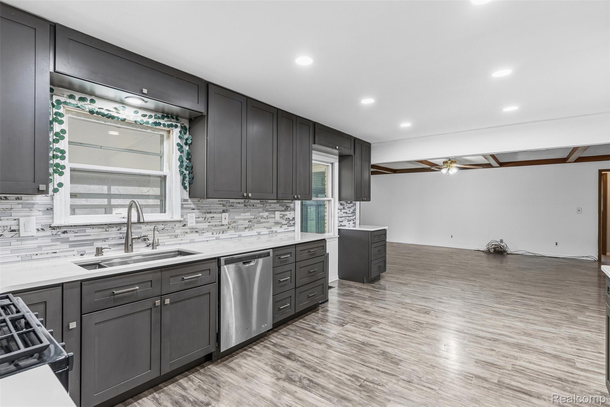 3432 South State Road Davison, MI 48423 - Photo 27 of 58 Kitchen with a ceiling fan, stainless steel dishwasher, plenty of natural light, light stone counters, and recessed lighting