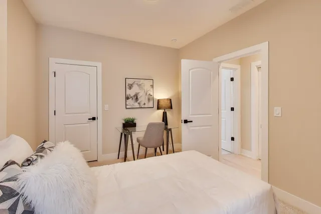 a bedroom with a bed and a bathroom