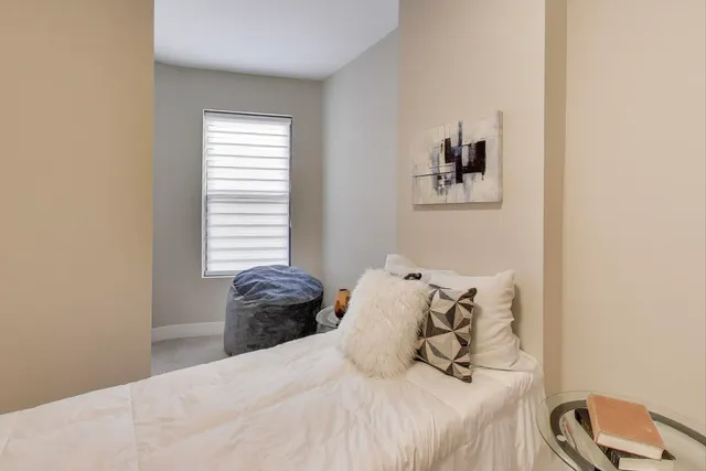 a bedroom with a bed and a chair