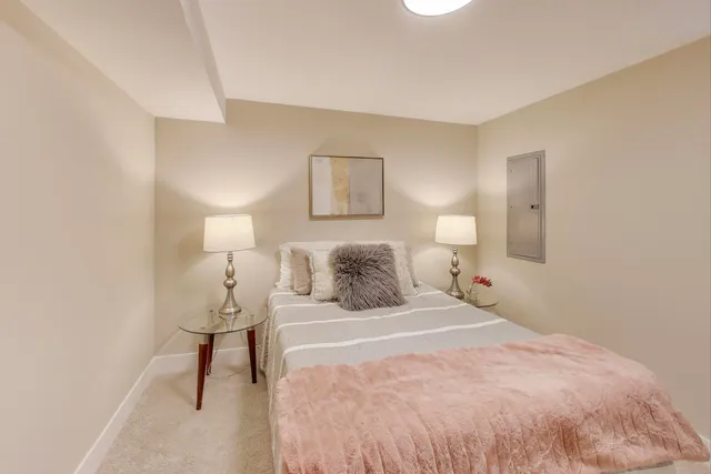 a bedroom with a bed and a lamp