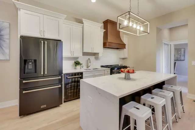 a kitchen with stainless steel appliances a sink a stove and refrigerator