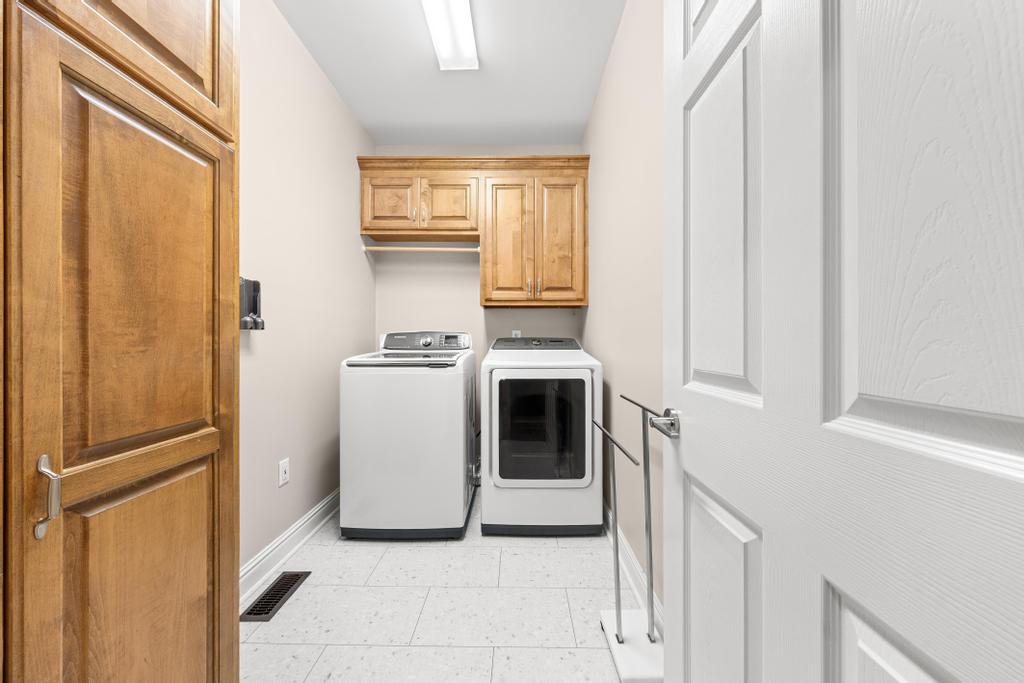 217 Maret Road Townville, SC 29689 - Photo 28 of 35 Functional laundry space featuring convenient upper cabinetry and modern appliances.