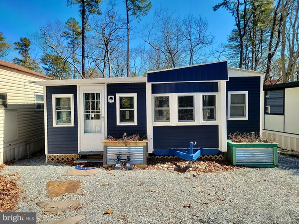 a backyard of a house with sofas fire pit and outdoor seating