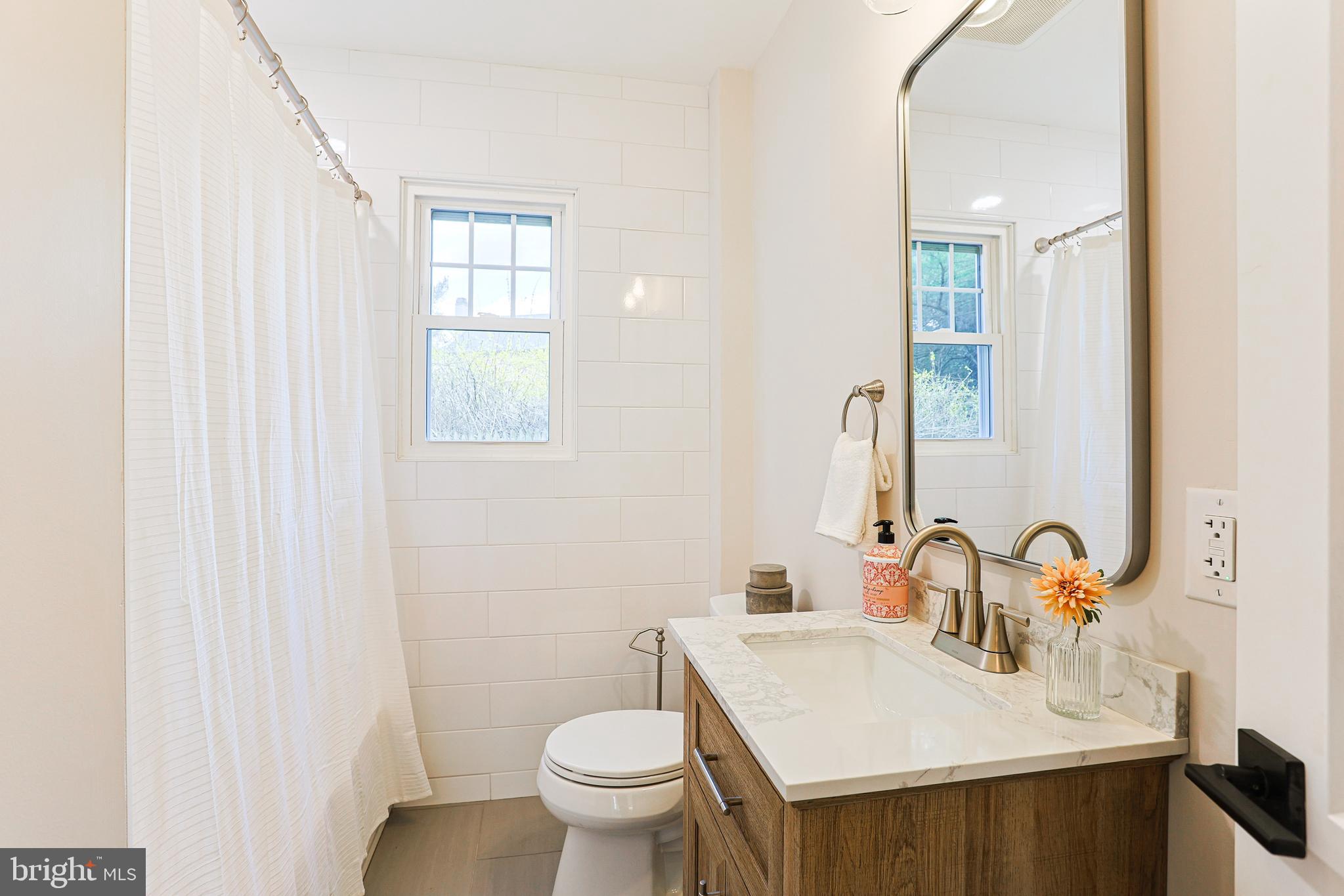 123 Sproul Road Malvern, PA 19355 - Photo 13 of 38 a bathroom with a sink toilet and a mirror