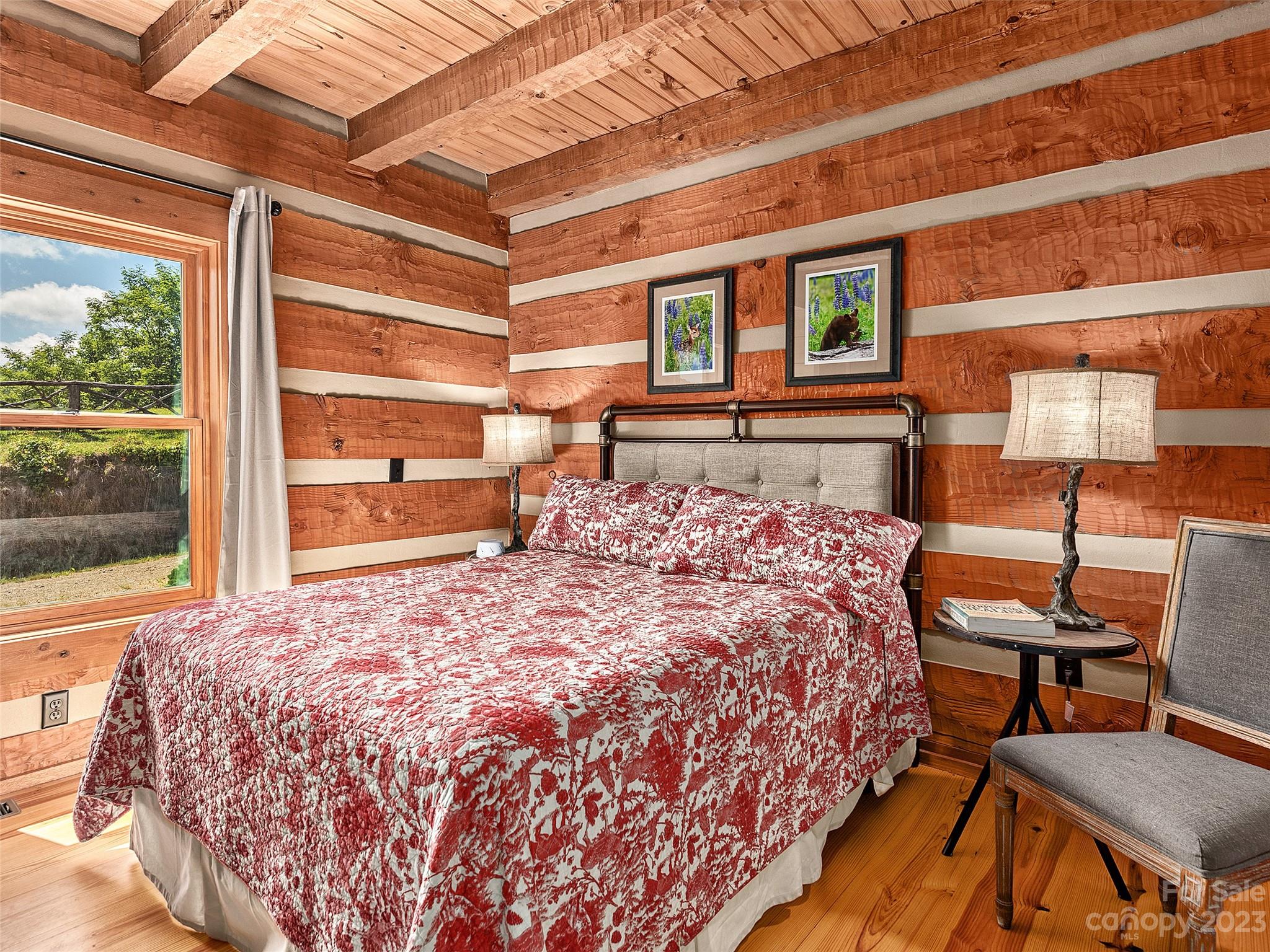 1038 Doggett Gap Road Hot Springs, NC 28743 - Photo 12 of 32 a bedroom with a bed and a dresser next to a window