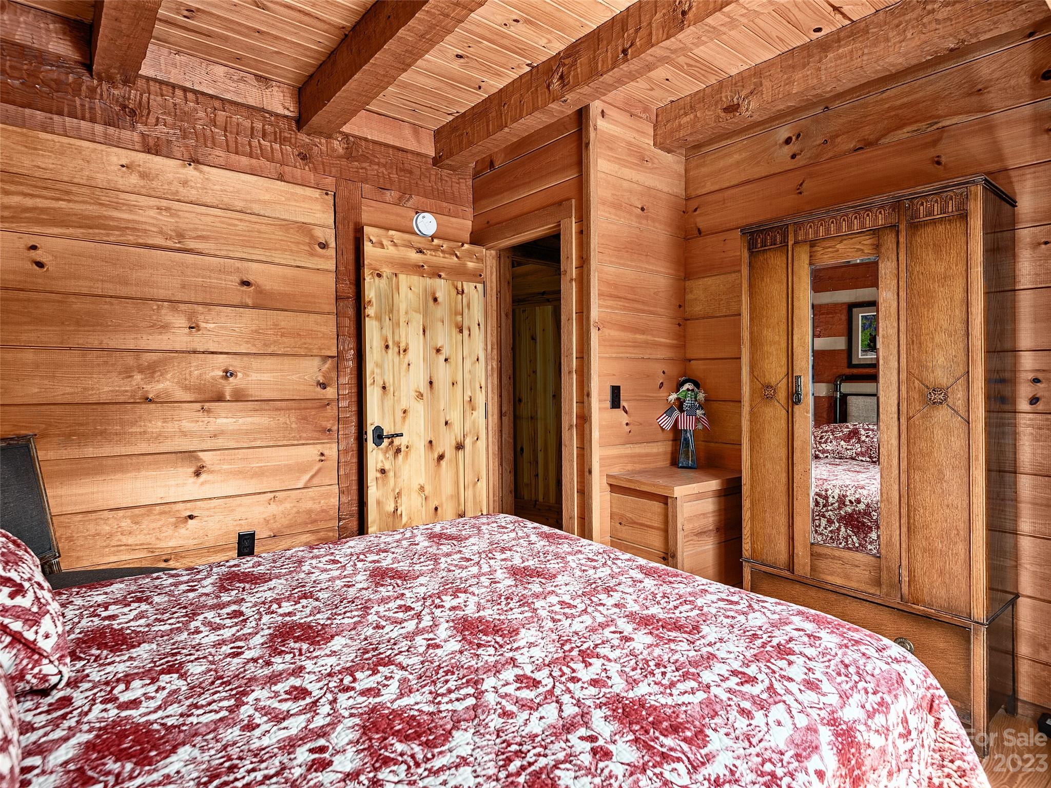 1038 Doggett Gap Road Hot Springs, NC 28743 - Photo 13 of 32 a bedroom with a bed and a cabinets