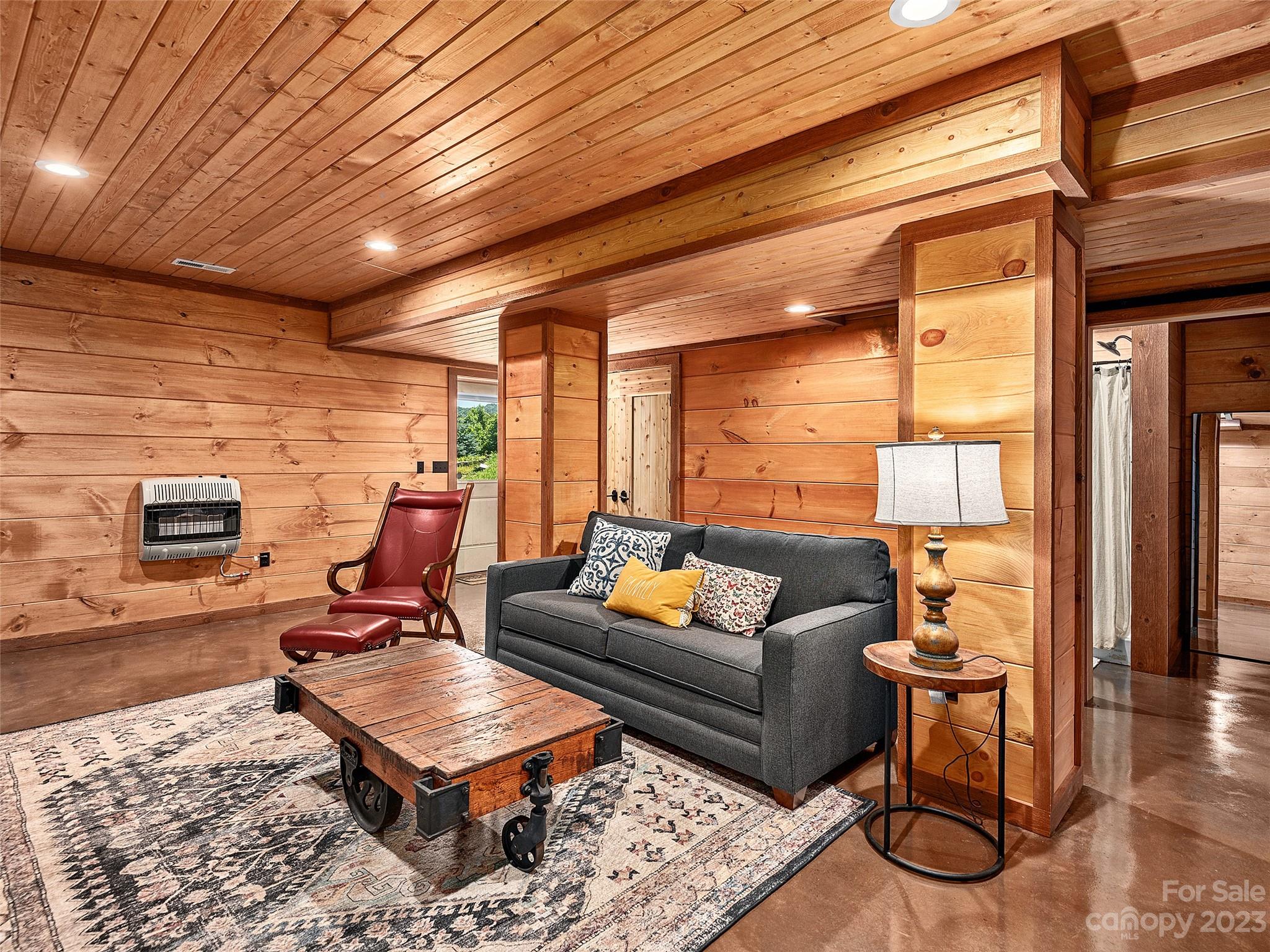 1038 Doggett Gap Road Hot Springs, NC 28743 - Photo 20 of 32 a living room with furniture a rug and a table