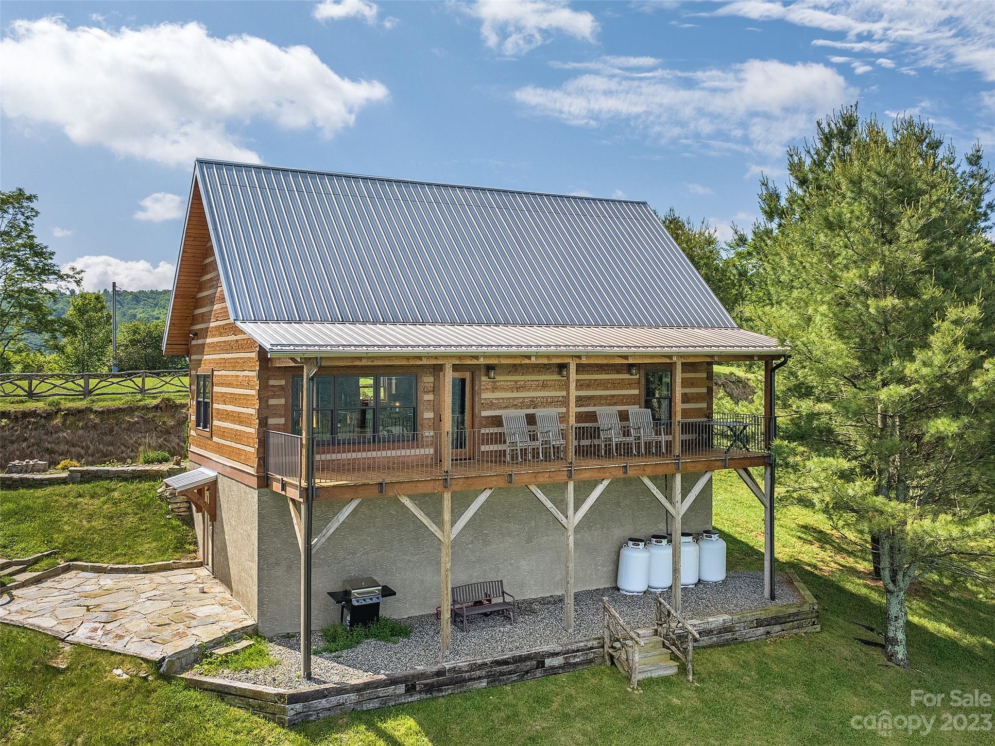 1038 Doggett Gap Road Hot Springs, NC 28743 - Photo 25 of 32 a roof deck with table and chairs under an umbrella