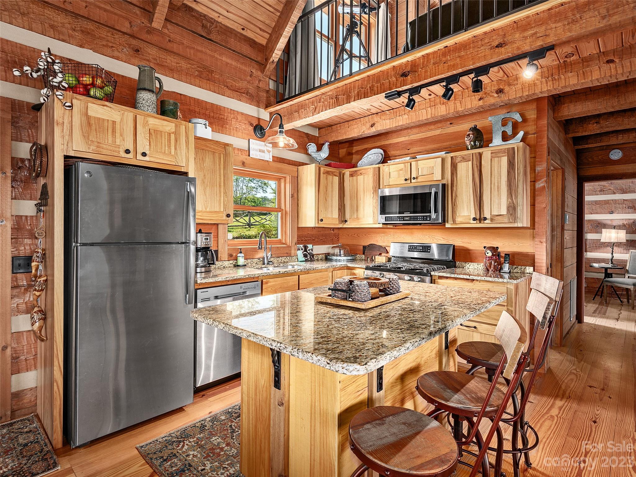 1038 Doggett Gap Road Hot Springs, NC 28743 - Photo 5 of 32 a kitchen with a refrigerator a stove and a dining table