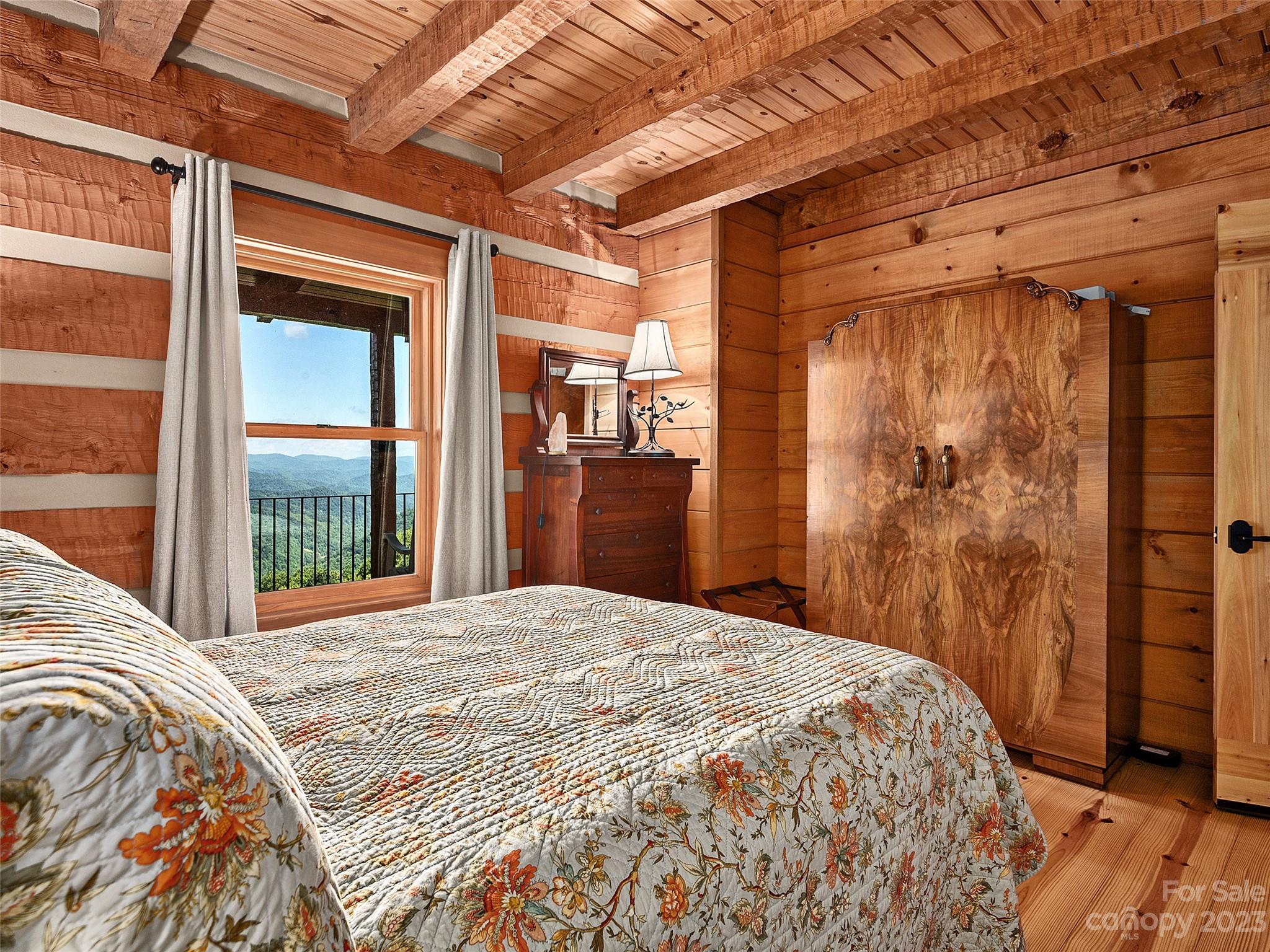 1038 Doggett Gap Road Hot Springs, NC 28743 - Photo 10 of 32 a bedroom with a large bed and wooden floor