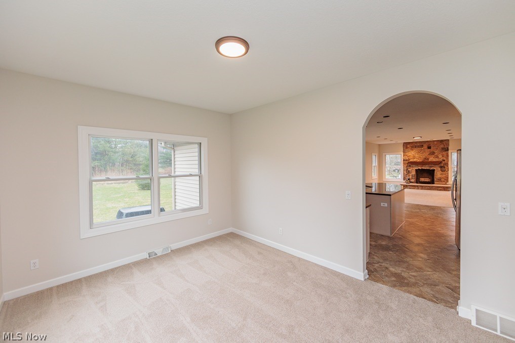 6947 Som Center Road Solon, OH 44139 - Photo 18 of 50 Tiled empty room with a fireplace