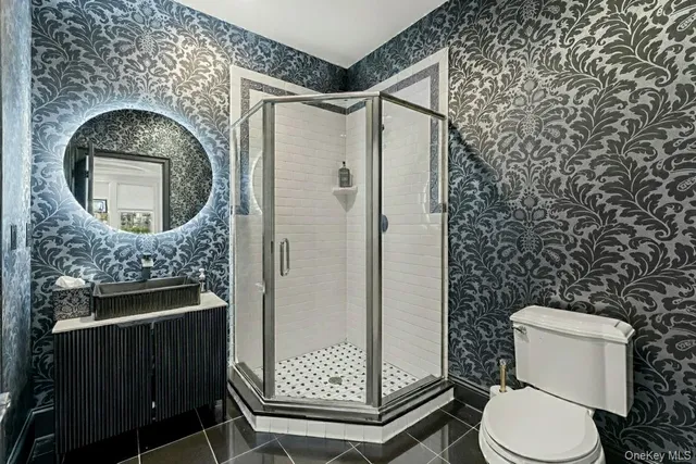 a bathroom with a toilet a sink and a shower