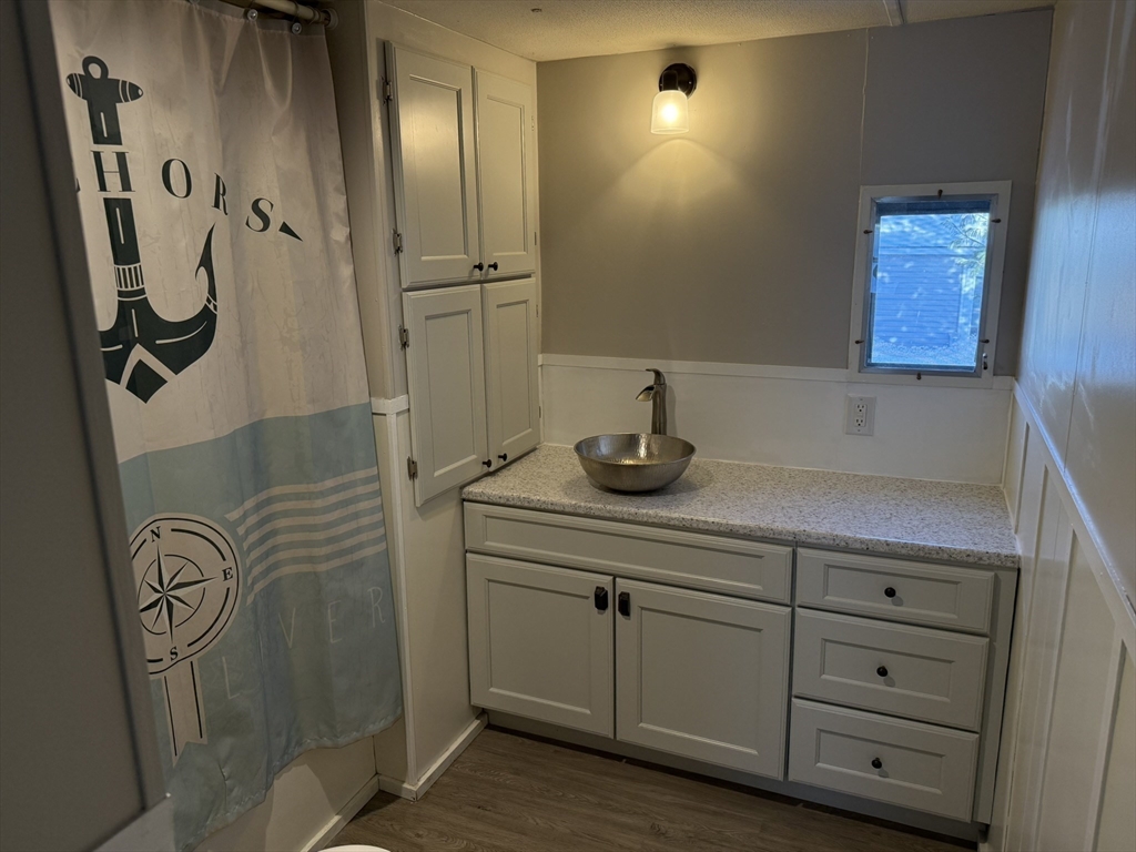 281 Chauncey Walker Street, Unit 188 Belchertown, MA 01007 - Photo 12 of 19 a bathroom with a sink a toilet and shower