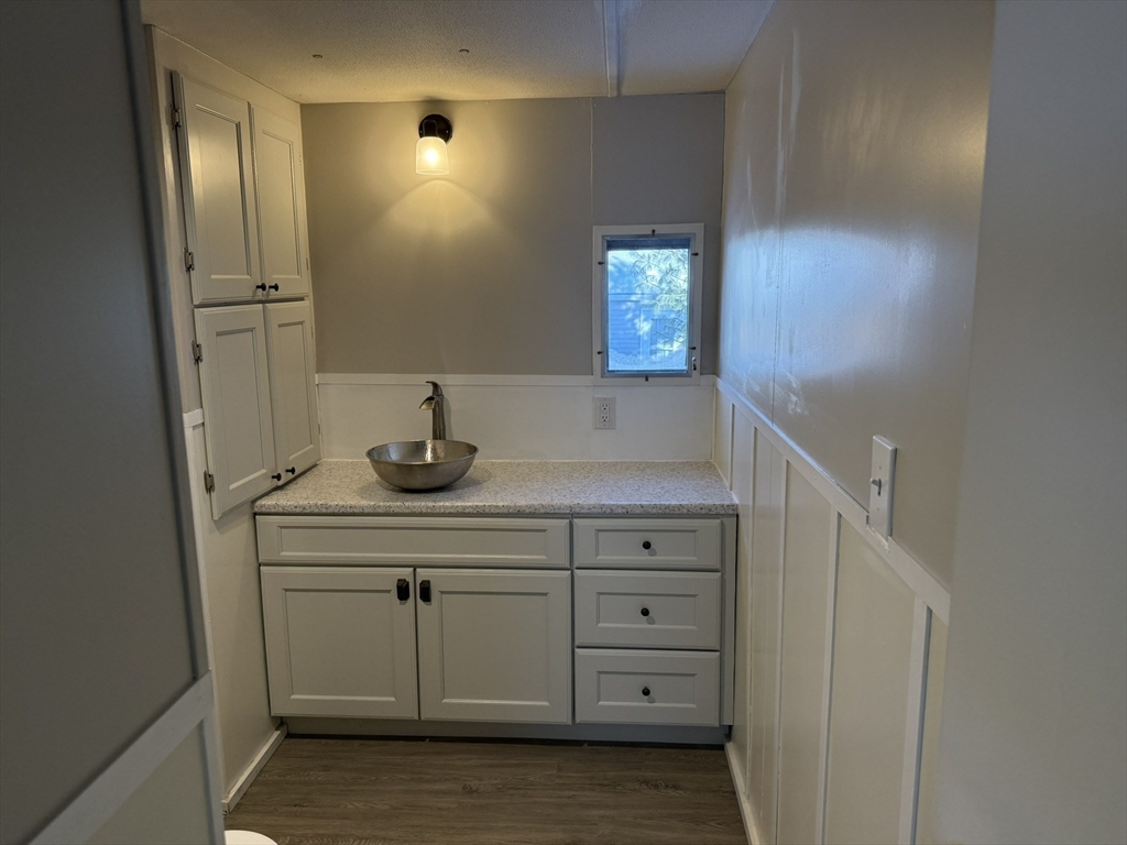 281 Chauncey Walker Street, Unit 188 Belchertown, MA 01007 - Photo 13 of 19 a bathroom with a sink and a mirror