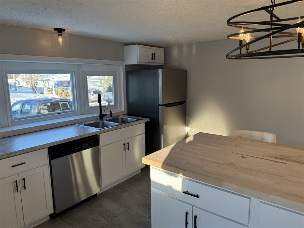 281 Chauncey Walker Street, Unit 188 Belchertown, MA 01007 - Photo 5 of 19 a kitchen with a sink and cabinets