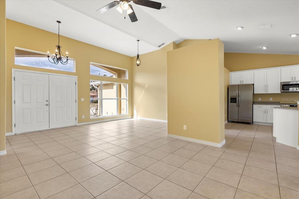 619 Rhodes Drive DeLand, FL 32720 - Photo 20 of 37 a view of a kitchen with a refrigerator and a stove top oven