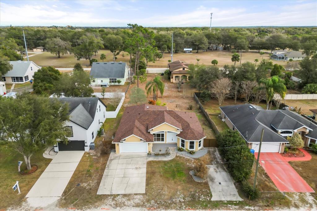 619 Rhodes Drive DeLand, FL 32720 - Photo 2 of 37 an aerial view of residential houses with outdoor space and parking