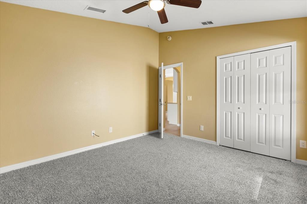 619 Rhodes Drive DeLand, FL 32720 - Photo 29 of 37 an empty room with a ceiling fan and a window
