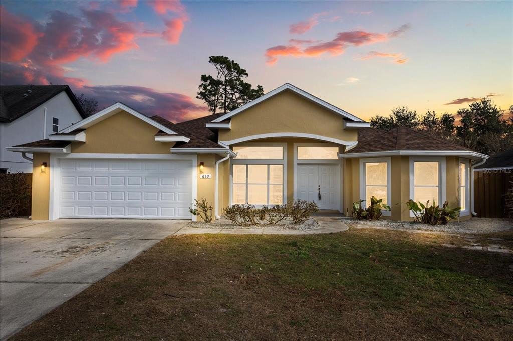 619 Rhodes Drive DeLand, FL 32720 - Photo 32 of 37 a front view of a house with a yard