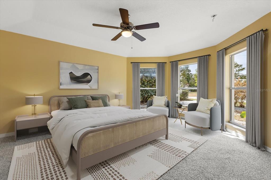 619 Rhodes Drive DeLand, FL 32720 - Photo 8 of 37 a bedroom with a large bed and a couch