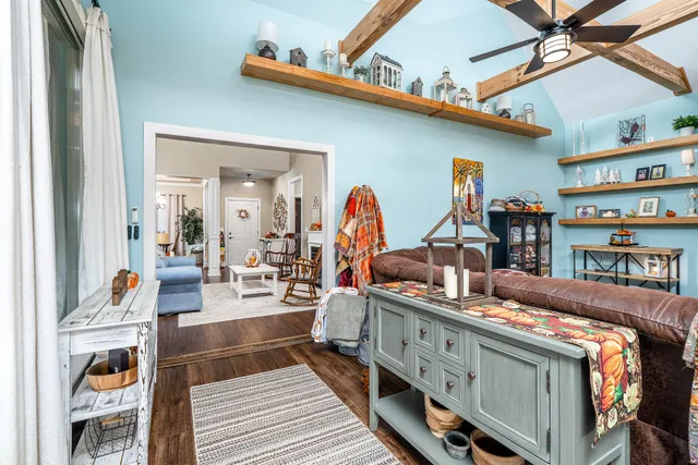 a bedroom with a large bed a rug and a chandelier