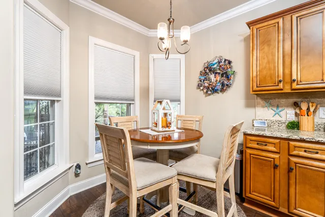 a living room with furniture a wooden floor and a large window
