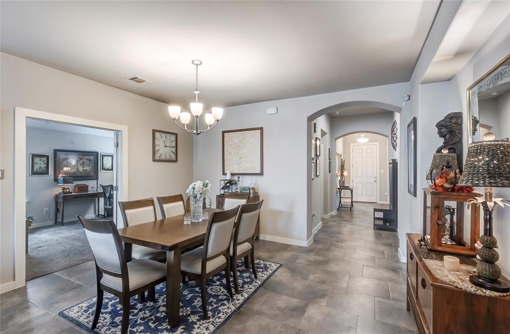 231 Windswept Way Kyle, TX 78640 - Photo 8 of 33 Dining space with a chandelier and arched walkways