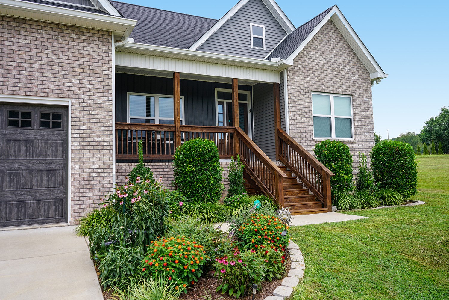 124 Piney Road Dickson, TN 37055 - Photo 12 of 39 a front view of a house with a yard and potted plants