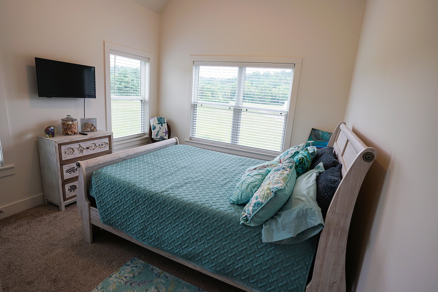 124 Piney Road Dickson, TN 37055 - Photo 32 of 39 a bedroom with a bed and a flat screen tv