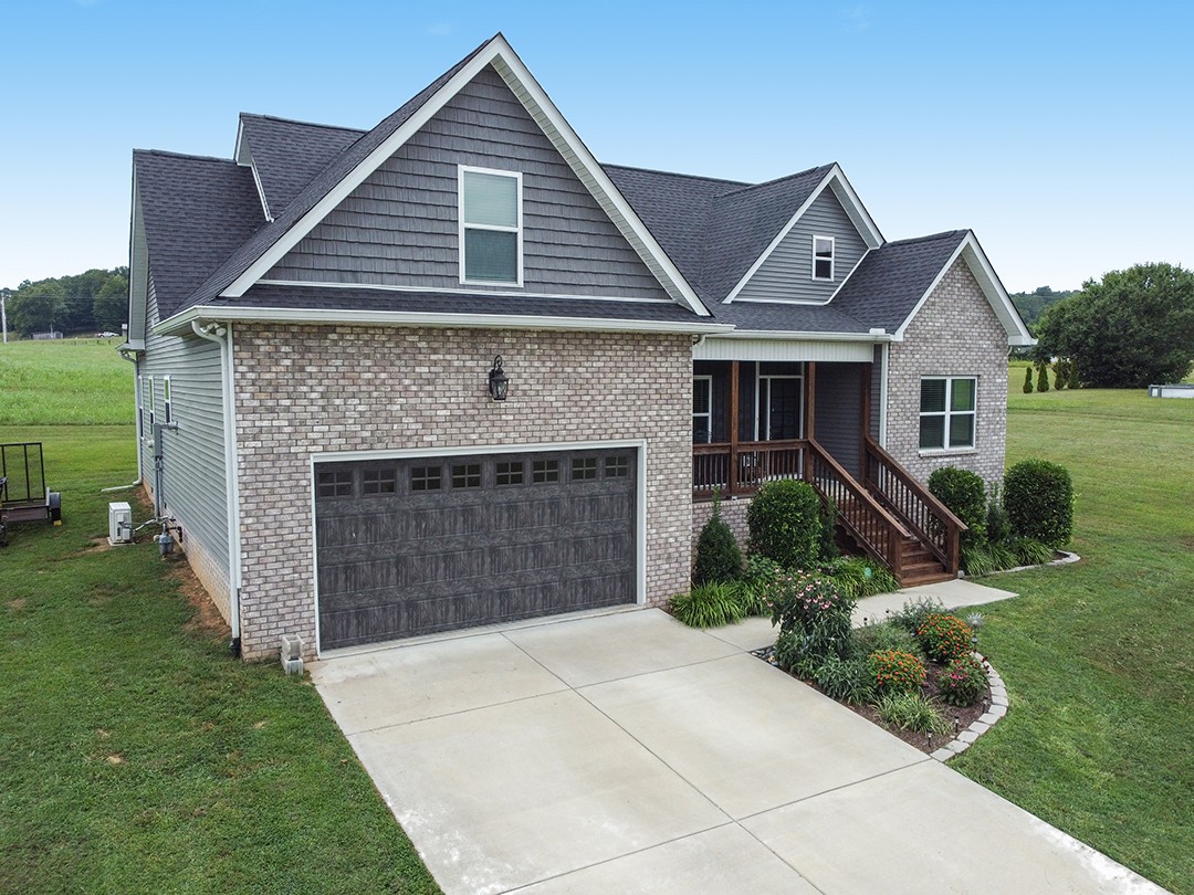 124 Piney Road Dickson, TN 37055 - Photo 5 of 39 a front view of a house with a garden