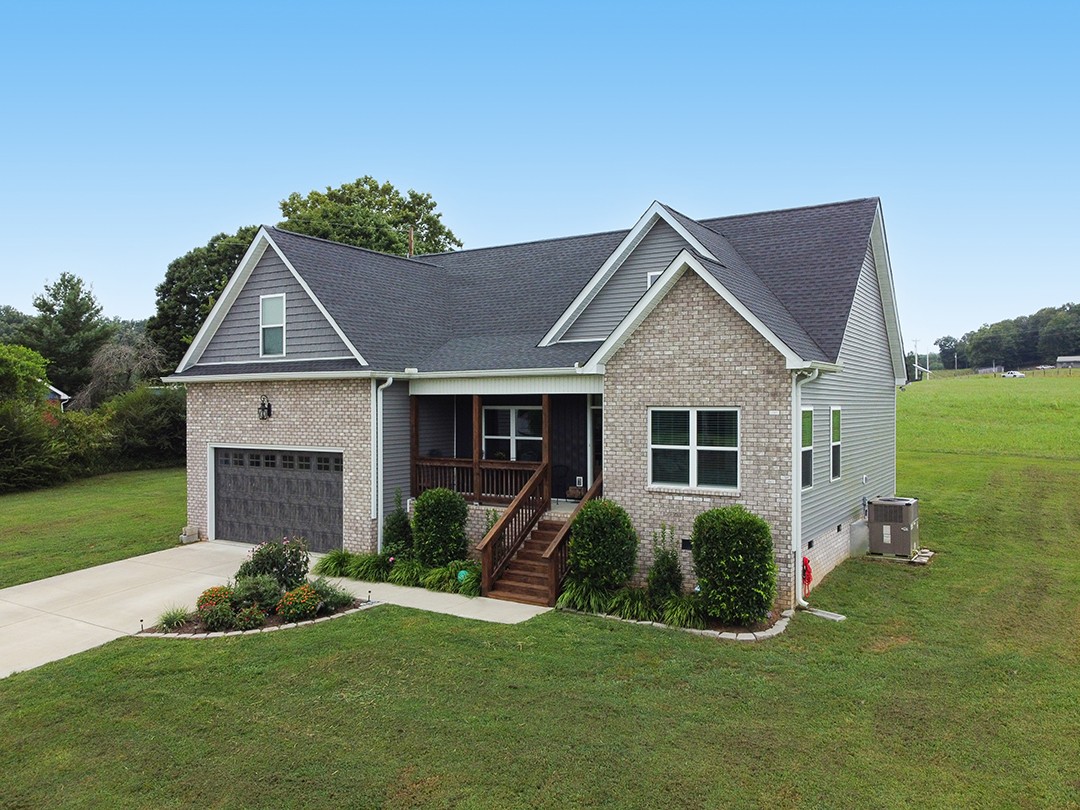 124 Piney Road Dickson, TN 37055 - Photo 7 of 39 a front view of a house with a yard and garage